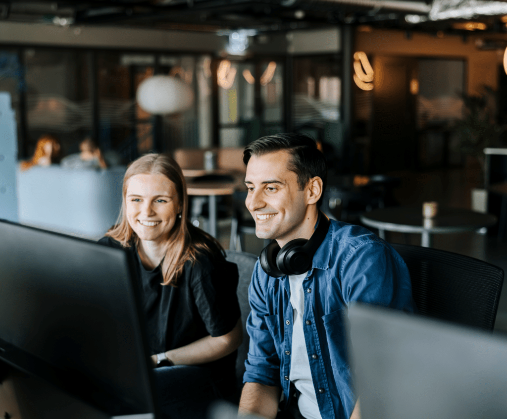 Stock image of two coworkers together on a computer