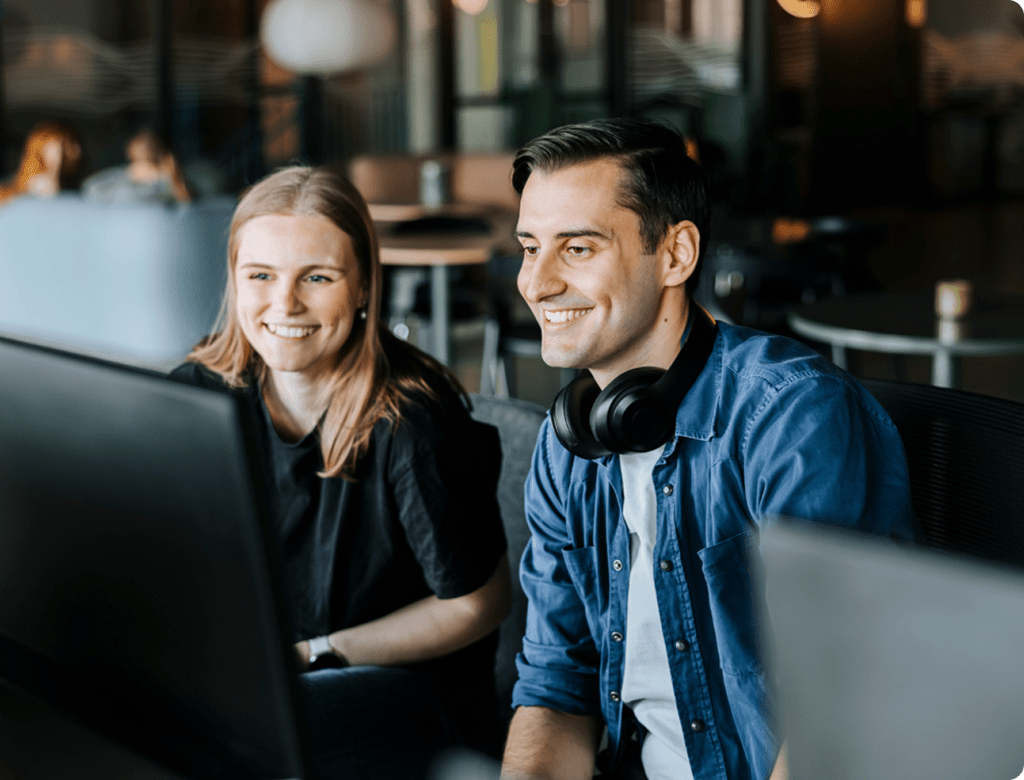 Stock image of two coworkers together on a computer