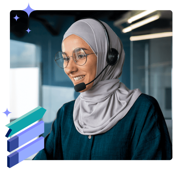 Woman with headset smiling and looking at a screen
